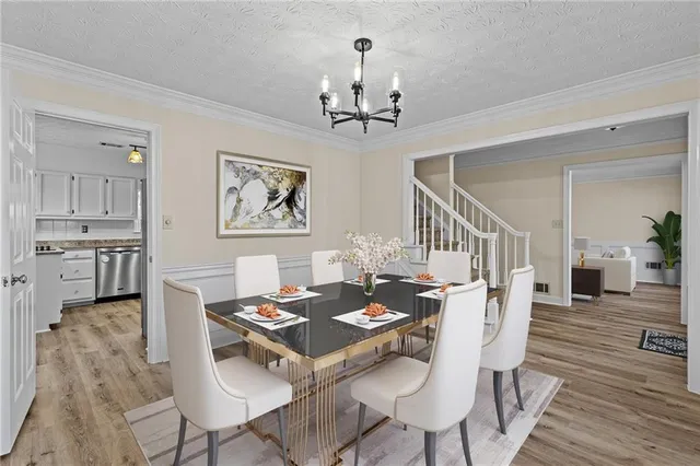 a view of a dining room with furniture wooden floor and a chandelier