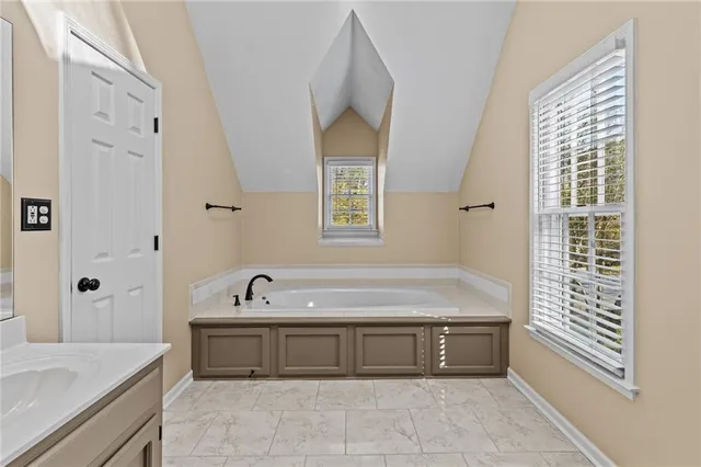 a bathroom with a bathtub and a sink