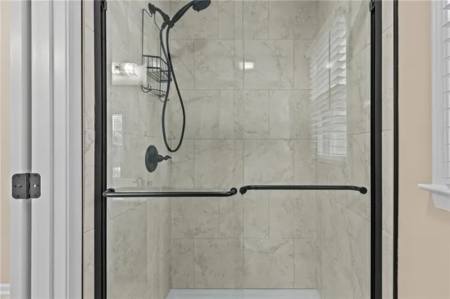 a bathroom with a glass shower door