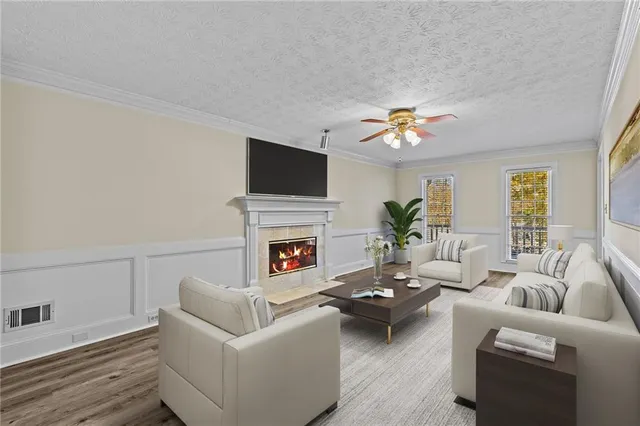 a living room with furniture a fireplace and a flat screen tv