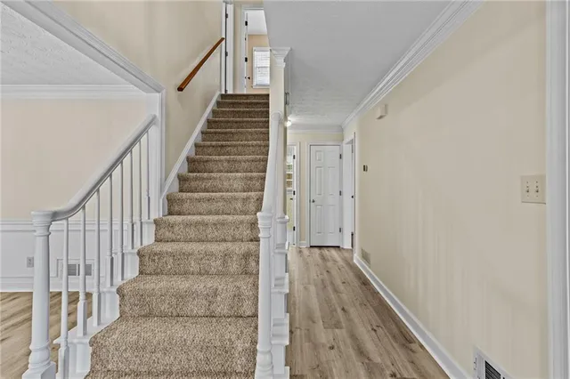 a view of a hallway with wooden floor and entryway