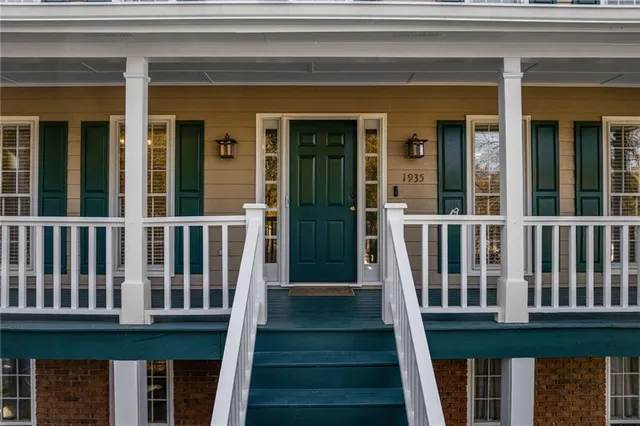 a view of a brick house with large windows