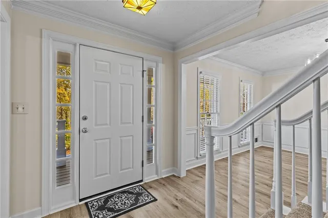 a view of entryway with wooden floor and livingroom view