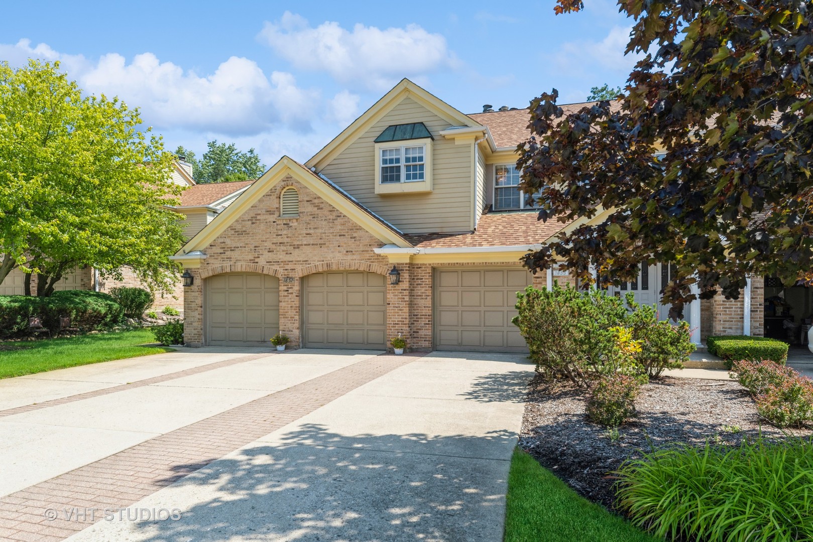 a front view of a house with a yard and garage