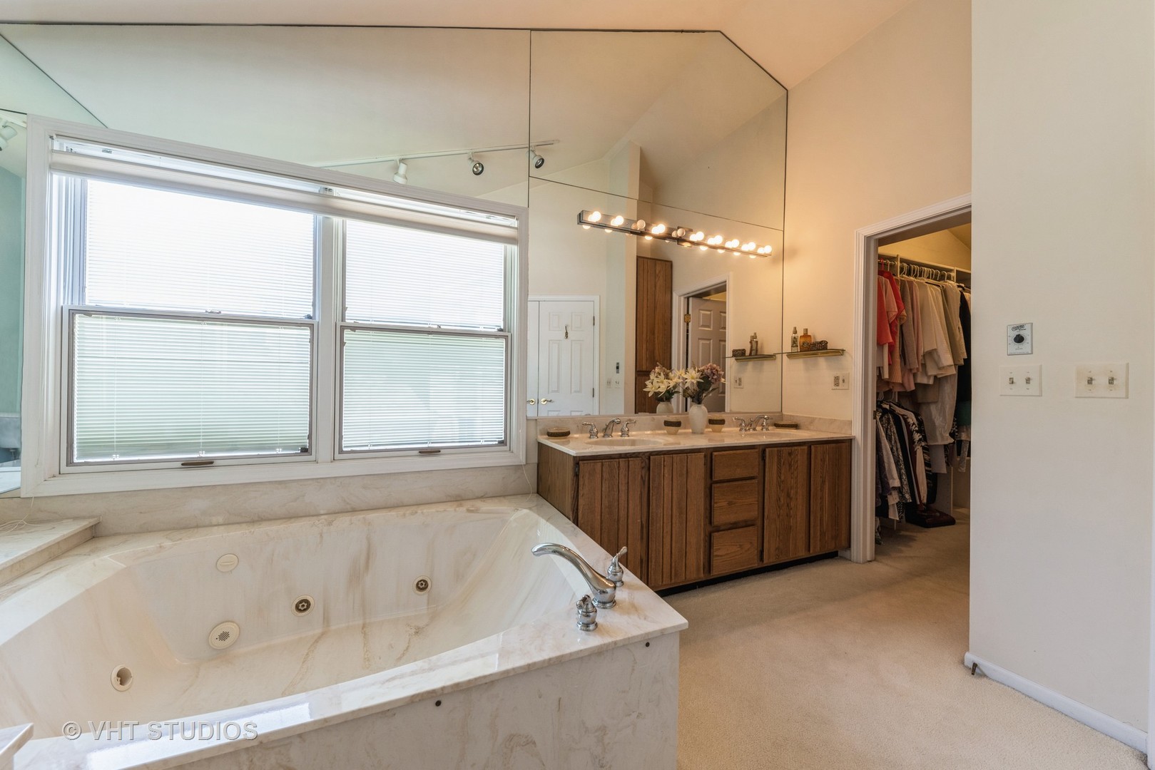 1857 Ashbury Lane, Unit 36 Inverness, IL 60067 - Photo 12 of 20 a bathroom with a tub a double vanity sink a window and a shower