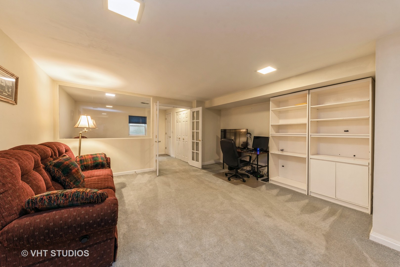 1857 Ashbury Lane, Unit 36 Inverness, IL 60067 - Photo 16 of 20 a living room with furniture and a large window with garden view