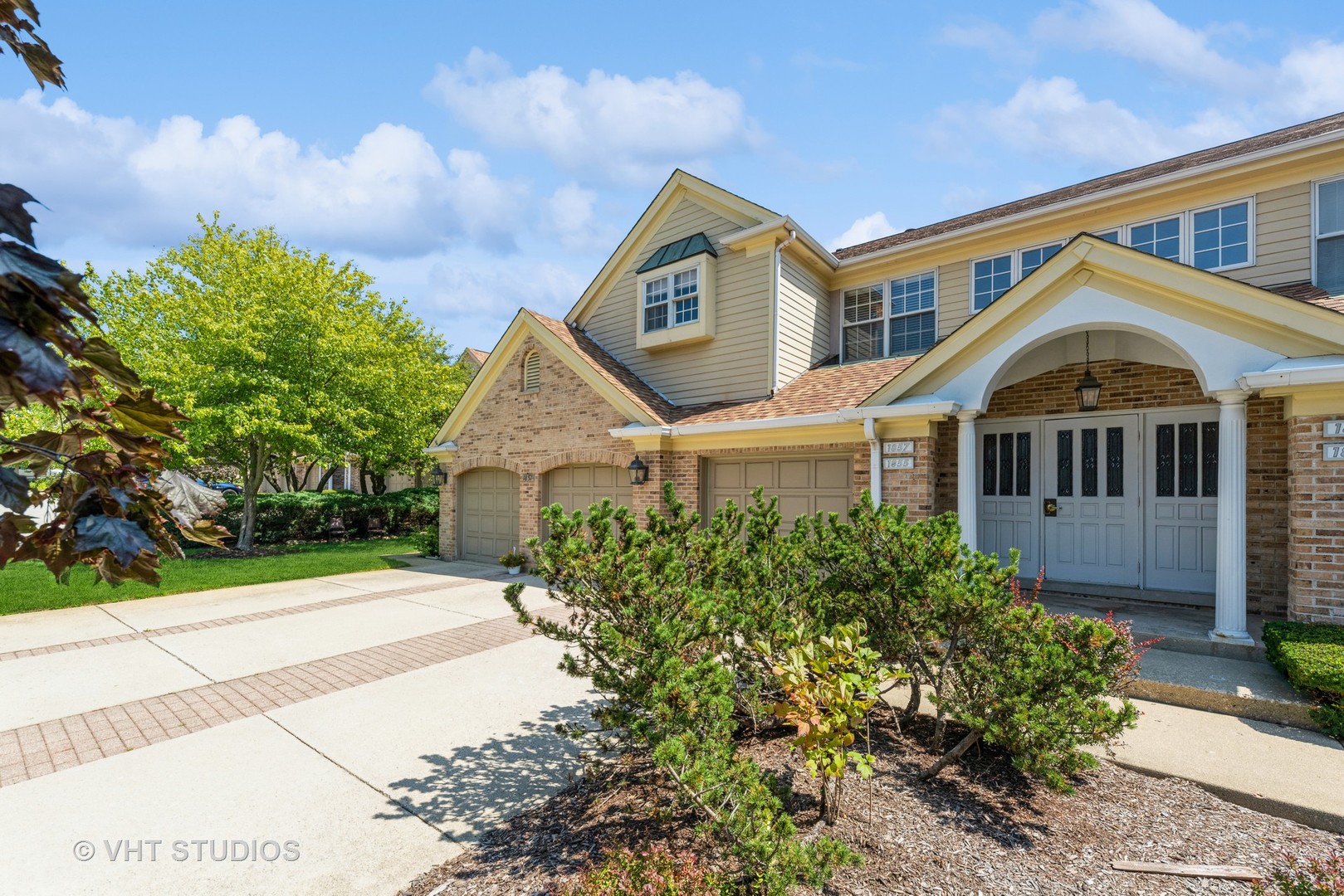 1857 Ashbury Lane, Unit 36 Inverness, IL 60067 - Photo 2 of 20 a front view of a house with garden