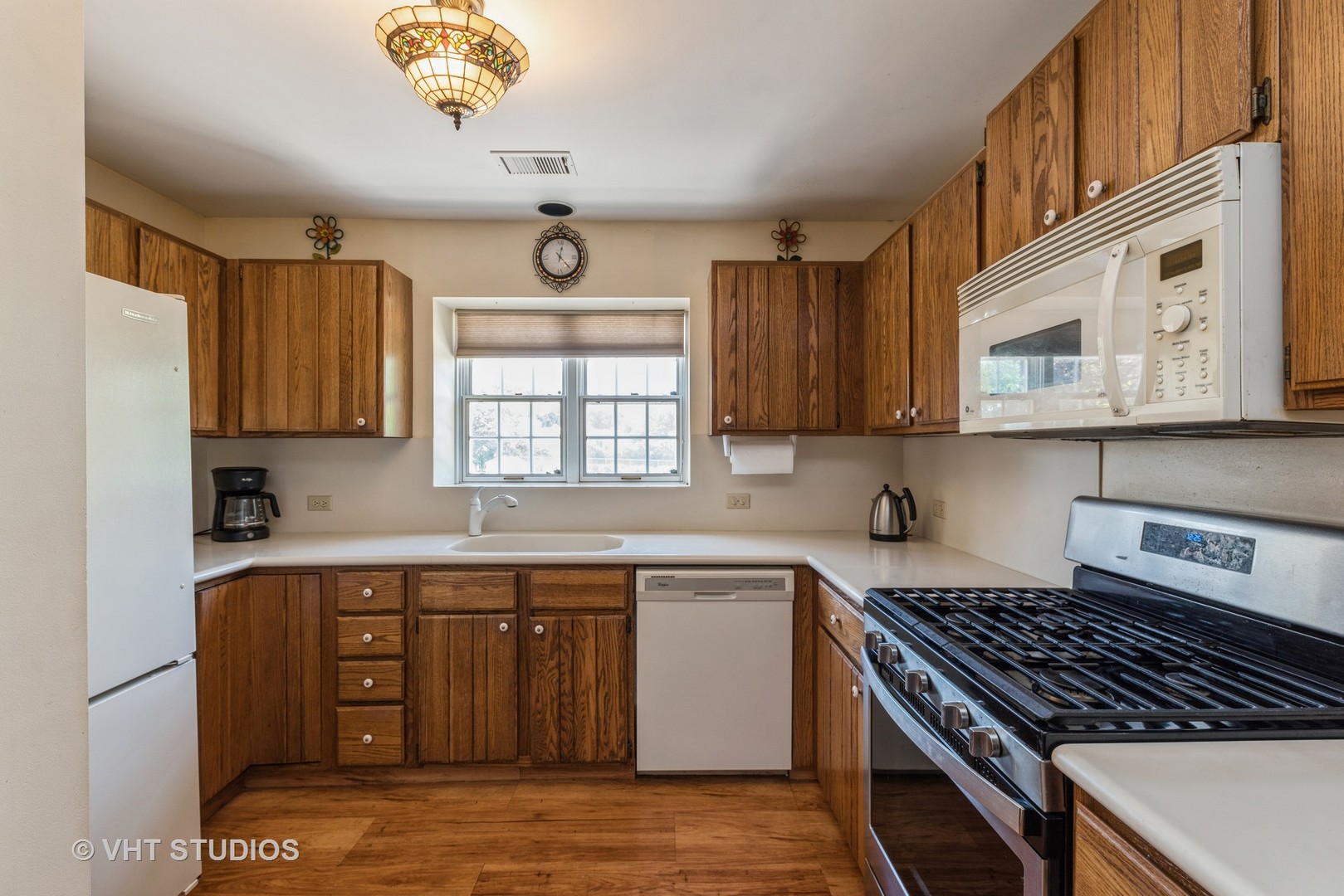 1857 Ashbury Lane, Unit 36 Inverness, IL 60067 - Photo 5 of 20 a kitchen with stainless steel appliances granite countertop a stove a sink and a microwave