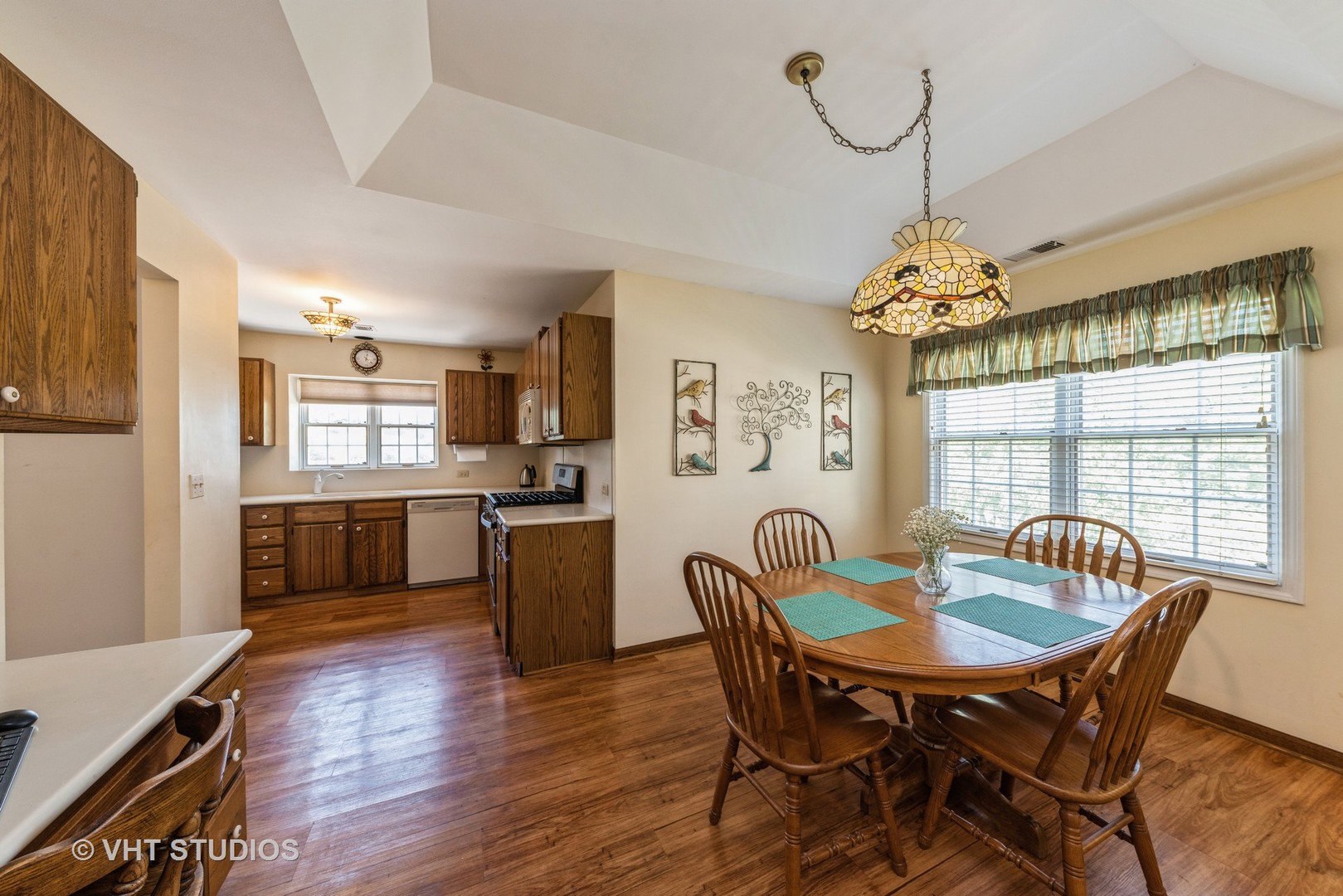 1857 Ashbury Lane, Unit 36 Inverness, IL 60067 - Photo 6 of 20 a view of a dining room with furniture window and wooden floor