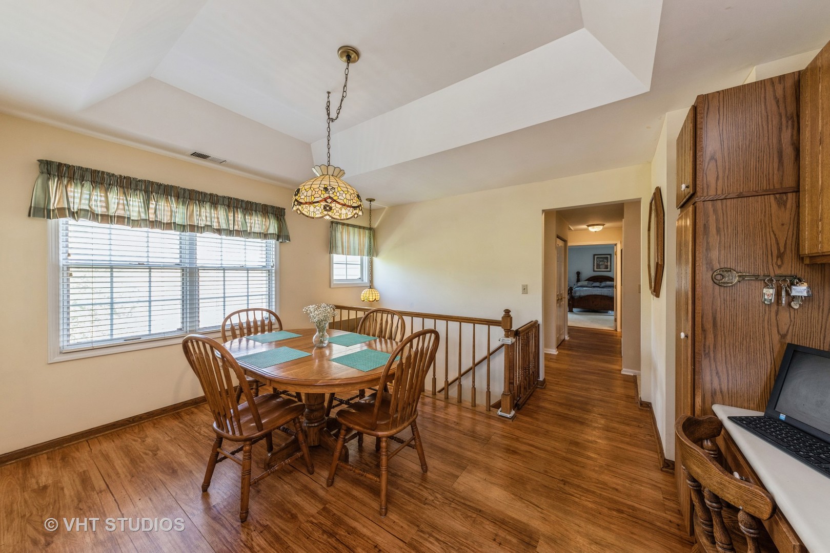1857 Ashbury Lane, Unit 36 Inverness, IL 60067 - Photo 7 of 20 a dining room with furniture a chandelier and wooden floor
