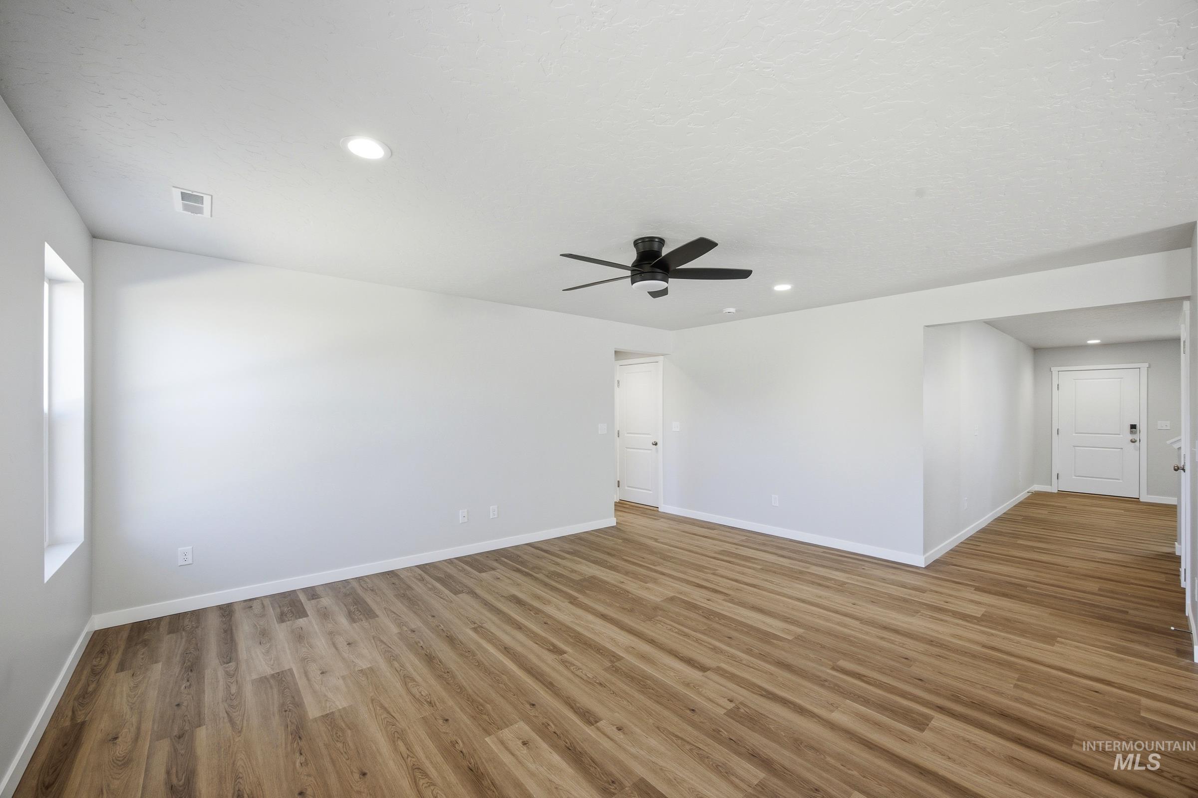13333 Bank Street Caldwell, ID 83607 - Photo 6 of 29 Wood-finish flooring throughout, recessed ceiling lighting, and a ceiling fan