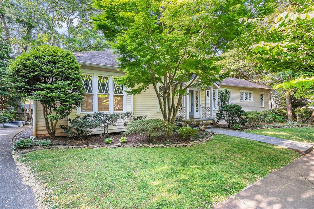 a view of a house with a yard and plants