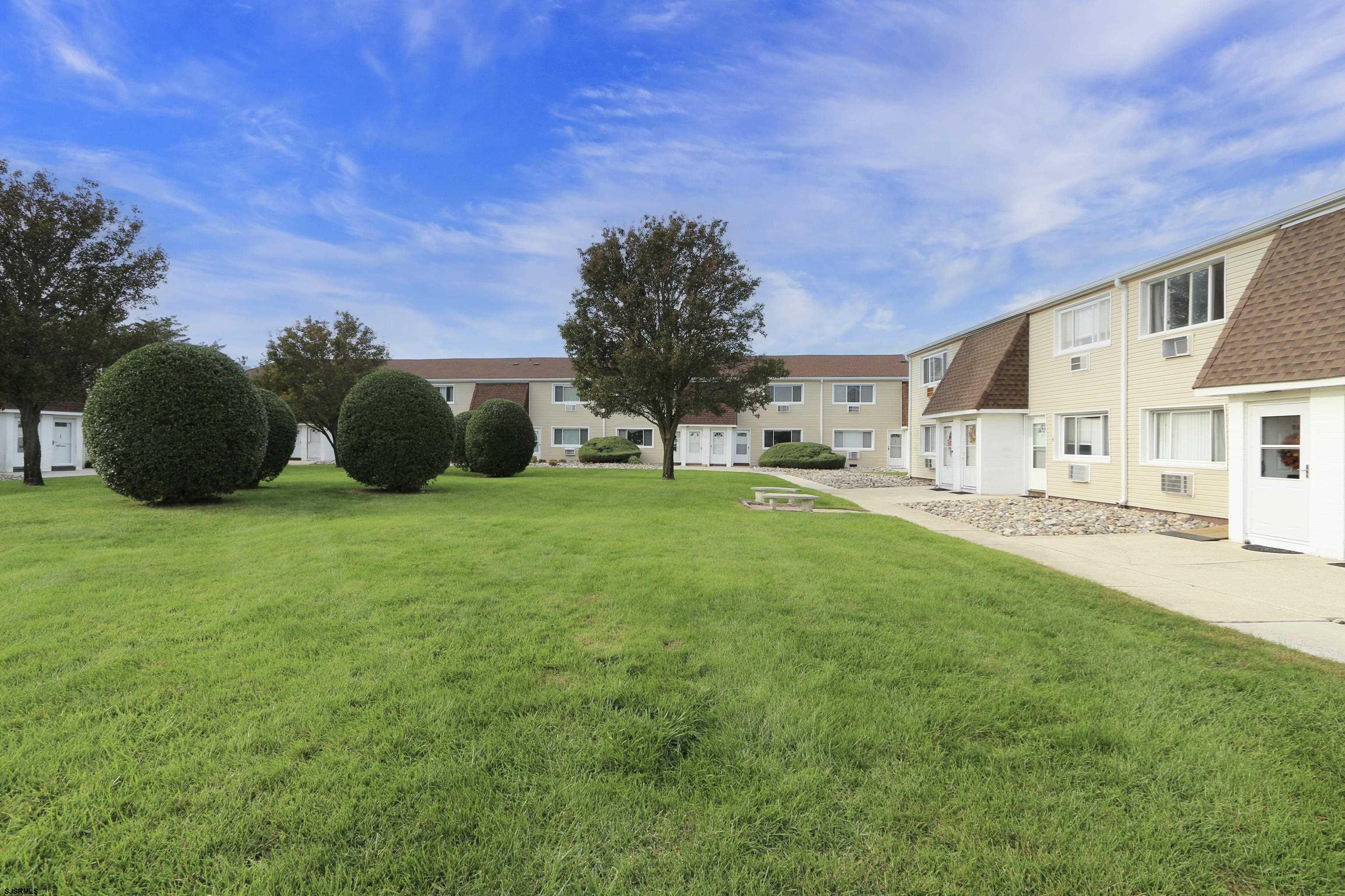 4901 Harbor Beach Boulevard, Unit F2 Brigantine, NJ 08203 - Photo 1 of 46 a view of an house with backyard and garden
