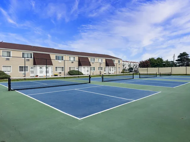 a view of an outdoor space and basketball court