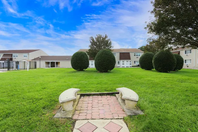 a view of a chair and table in backyard of the house