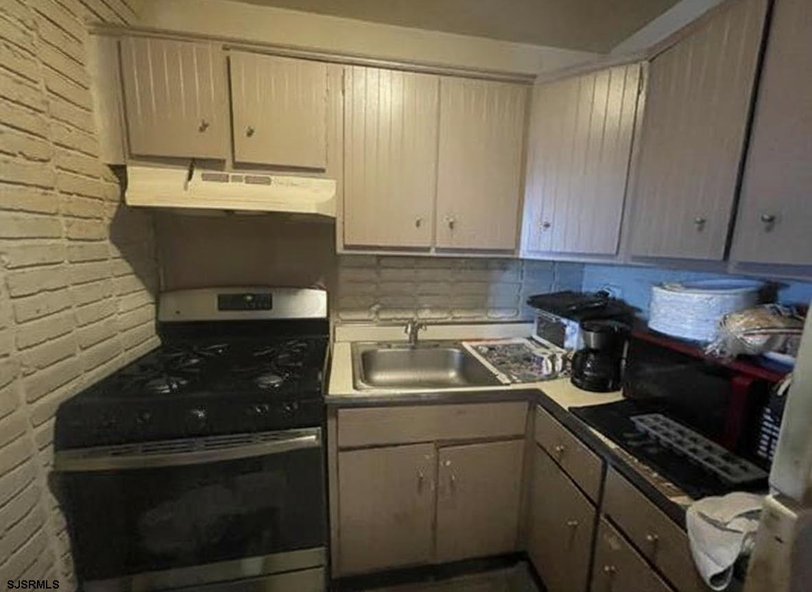 4901 Harbor Beach Boulevard, Unit F2 Brigantine, NJ 08203 - Photo 4 of 46 a kitchen with a sink and cabinets