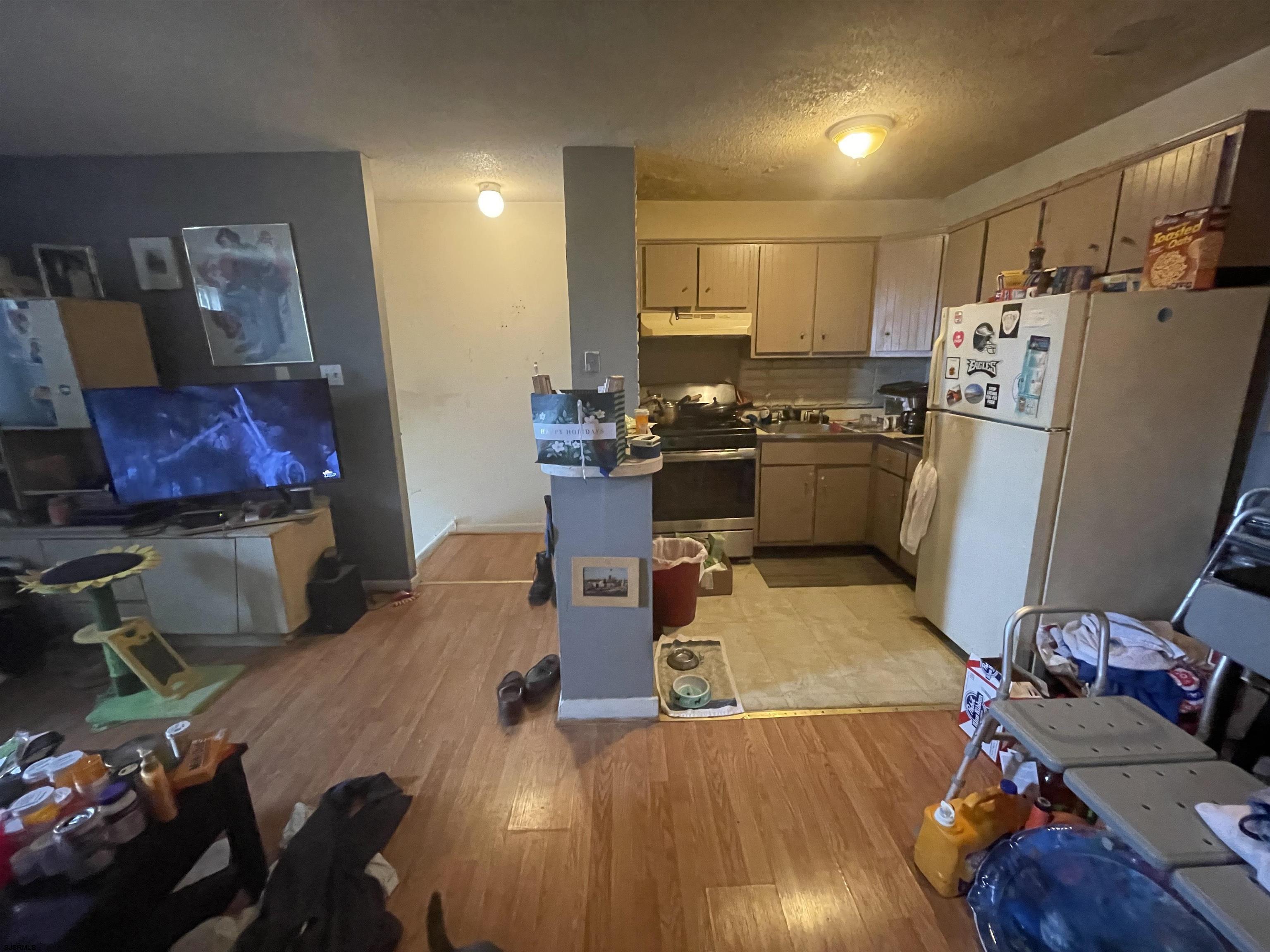 4901 Harbor Beach Boulevard, Unit F2 Brigantine, NJ 08203 - Photo 41 of 46 a kitchen with sink refrigerator and microwave