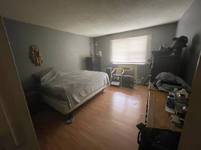 a living room with furniture a flat screen tv and a table