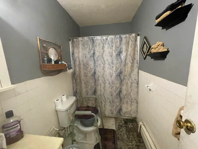 a room with furniture a refrigerator and a stove