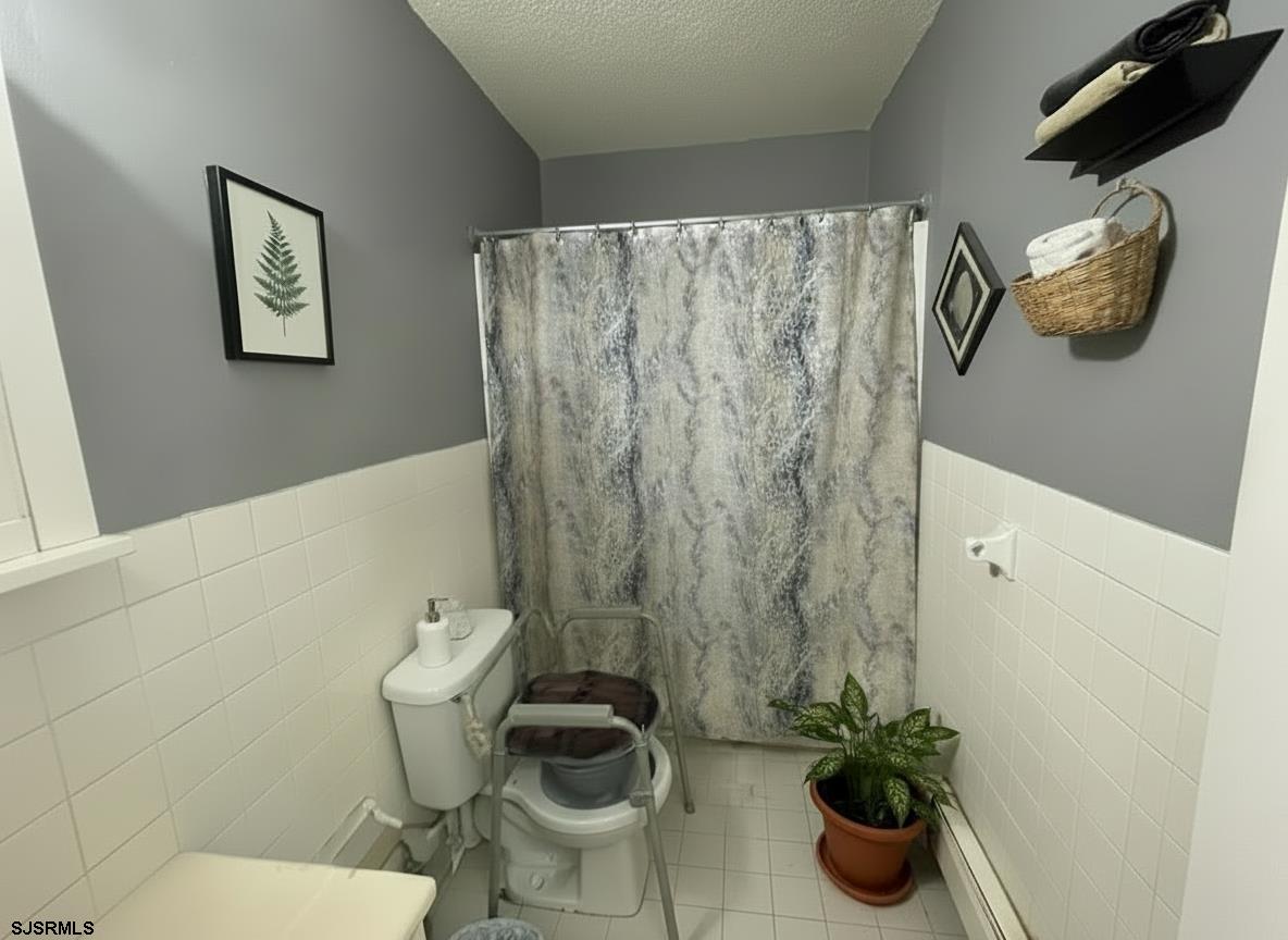 4901 Harbor Beach Boulevard, Unit F2 Brigantine, NJ 08203 - Photo 7 of 46 a bathroom with a toilet and a sink