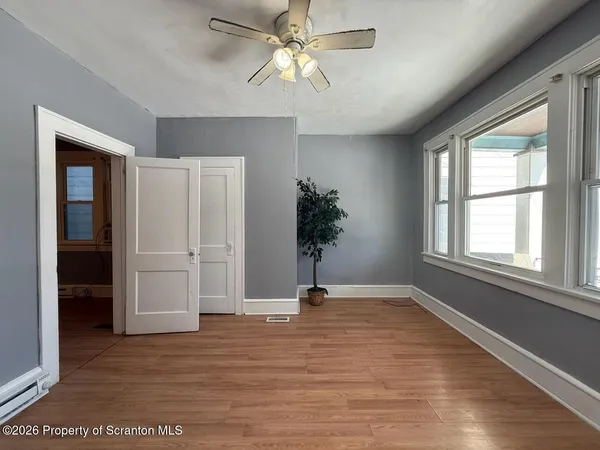 wooden floor in an empty room with a window
