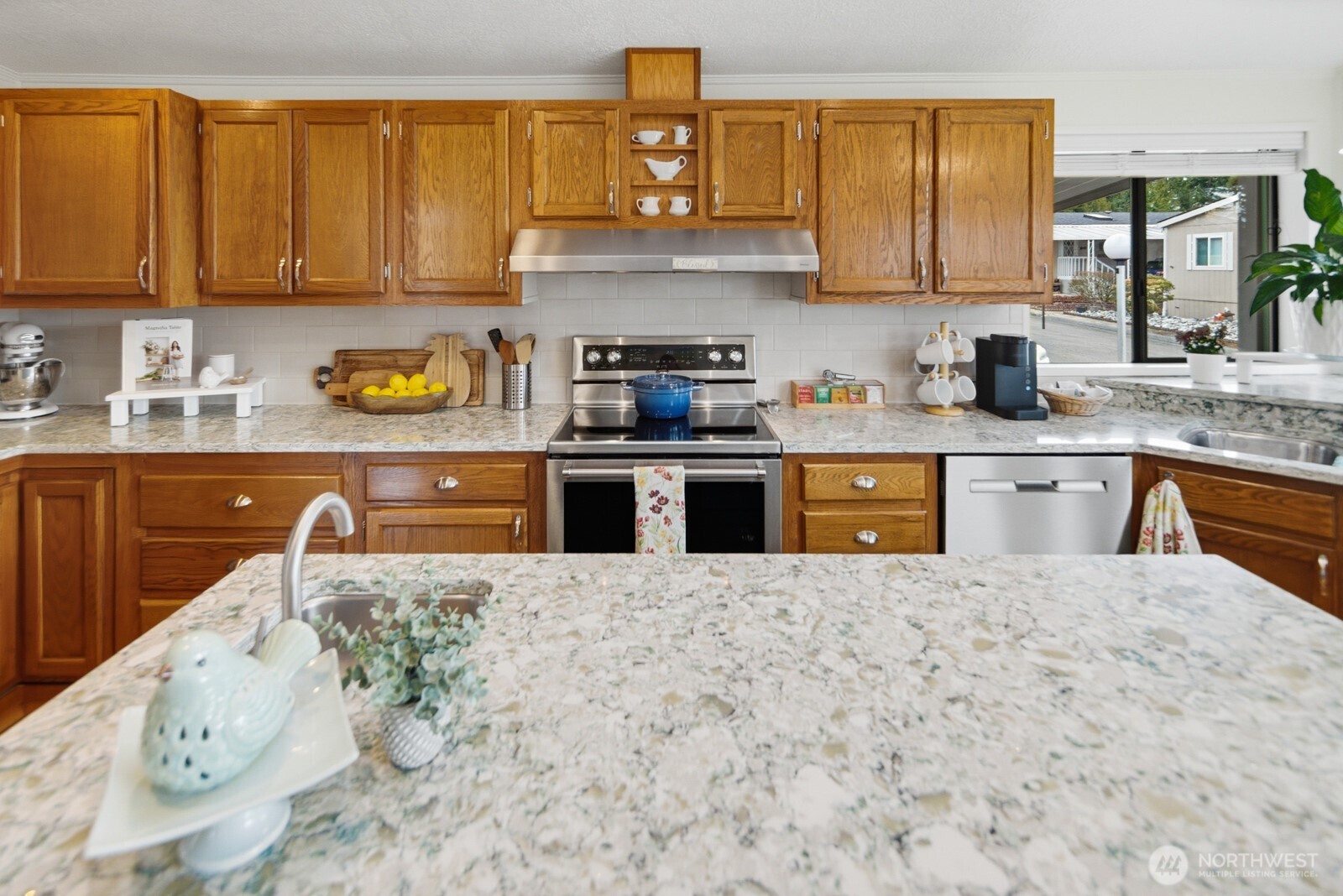 1427 100th Street Southwest, Unit 149 Everett, WA 98204 - Photo 11 of 40 a kitchen with stainless steel appliances granite countertop a stove a sink and a refrigerator