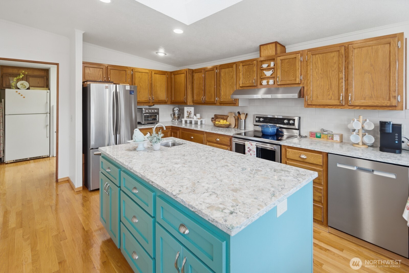 1427 100th Street Southwest, Unit 149 Everett, WA 98204 - Photo 12 of 40 a kitchen with stainless steel appliances granite countertop a sink dishwasher stove and refrigerator with wooden floor