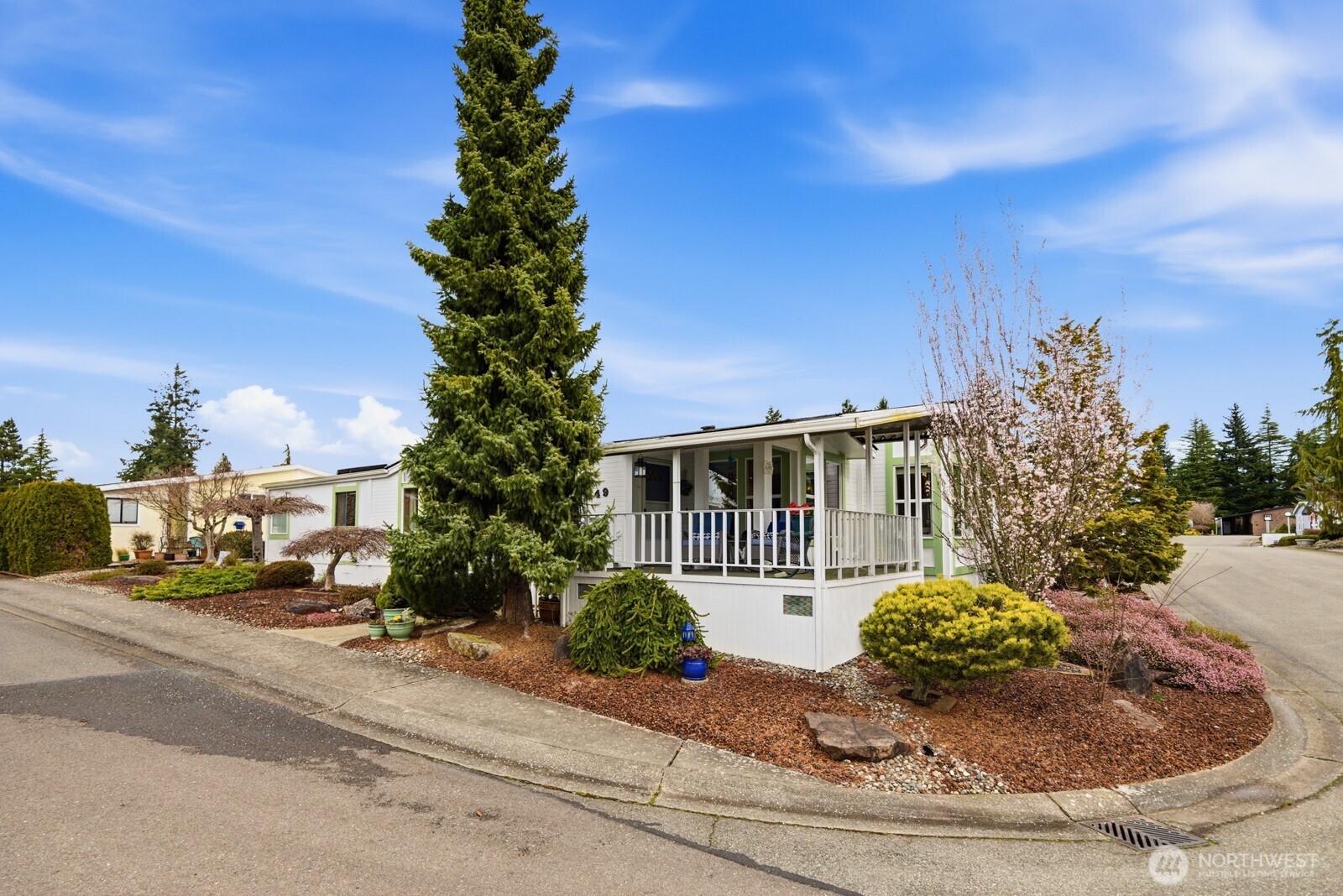 1427 100th Street Southwest, Unit 149 Everett, WA 98204 - Photo 33 of 40 a view of a house with a yard and potted plants