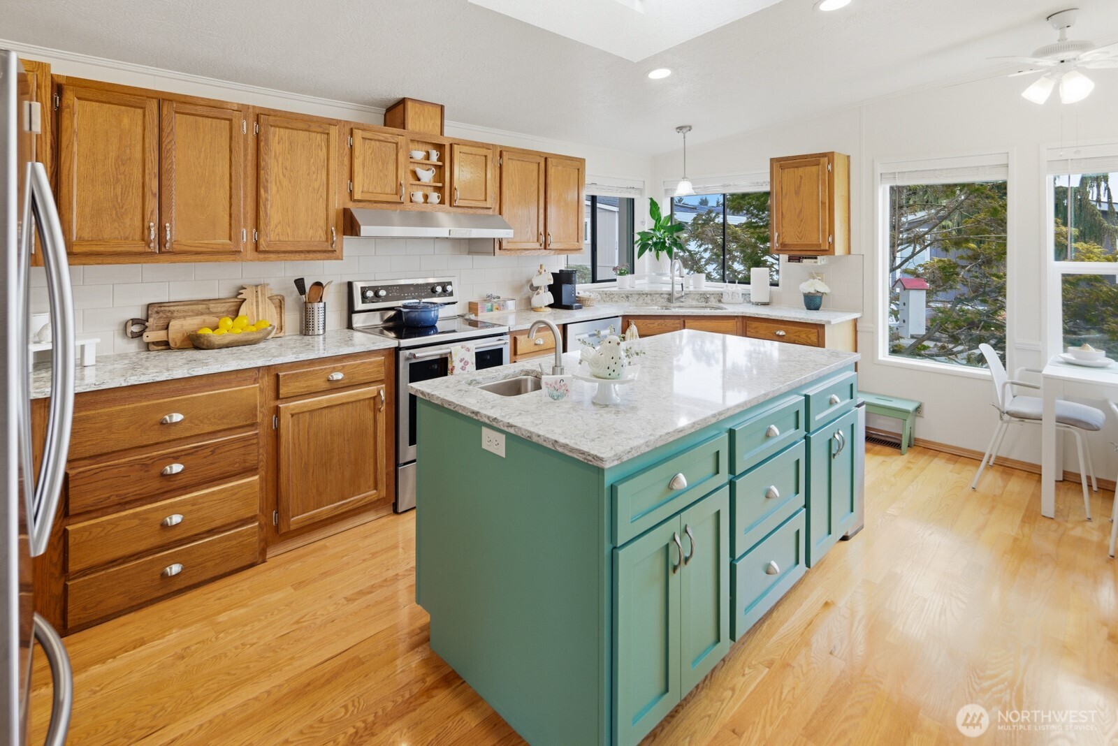 1427 100th Street Southwest, Unit 149 Everett, WA 98204 - Photo 9 of 40 a kitchen with stainless steel appliances granite countertop a sink a stove and a refrigerator