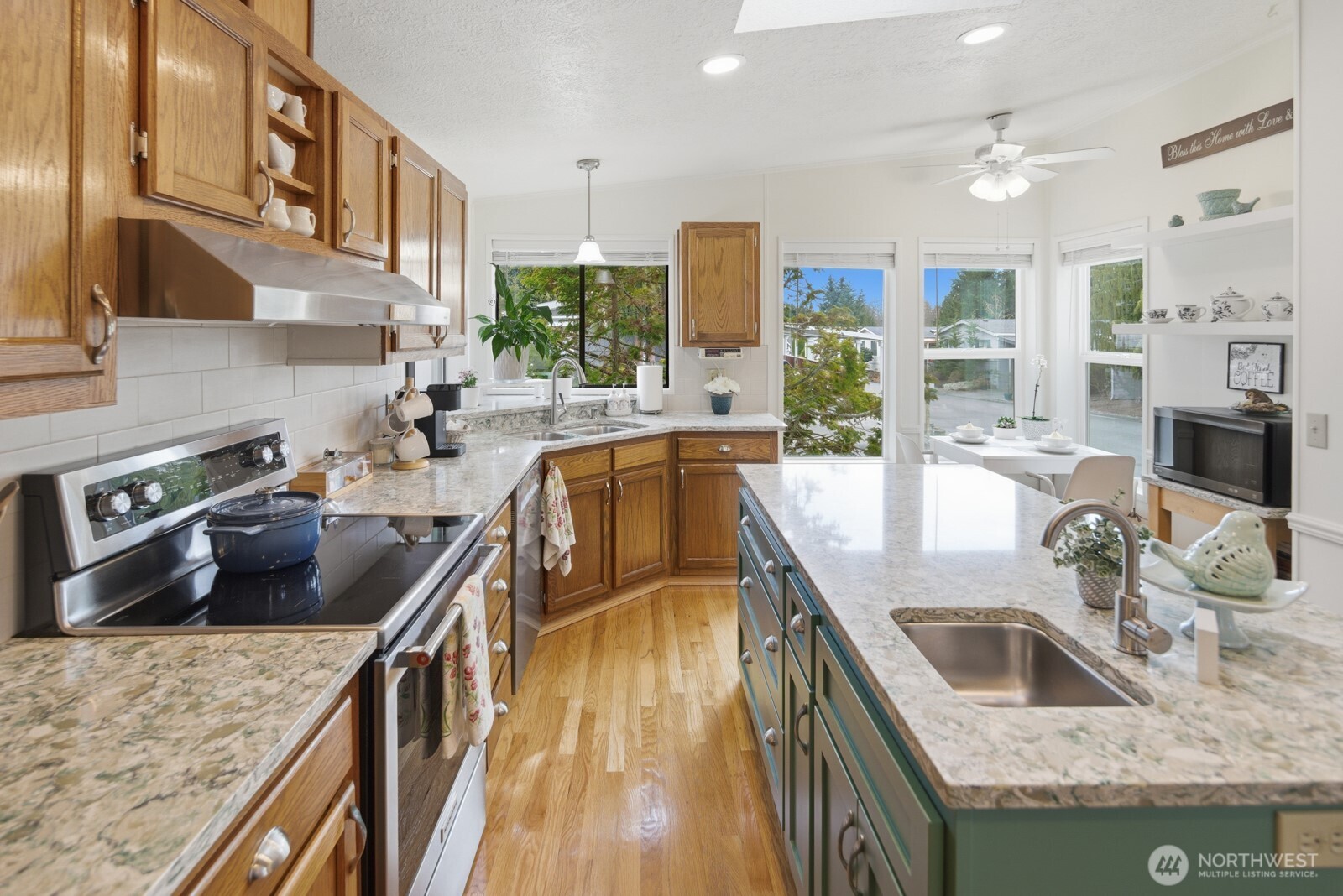 1427 100th Street Southwest, Unit 149 Everett, WA 98204 - Photo 10 of 40 a kitchen with stainless steel appliances granite countertop a sink a stove and a refrigerator