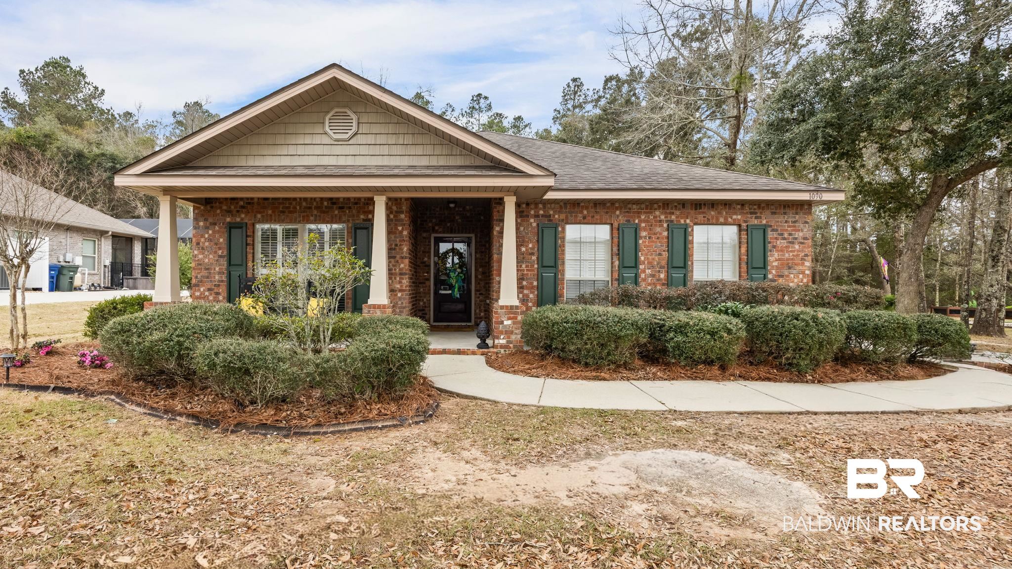 1090 Melbourne Court Foley, AL 36535 - Photo 3 of 38 View of front facade featuring brick siding, covered porch, and a shingled roof