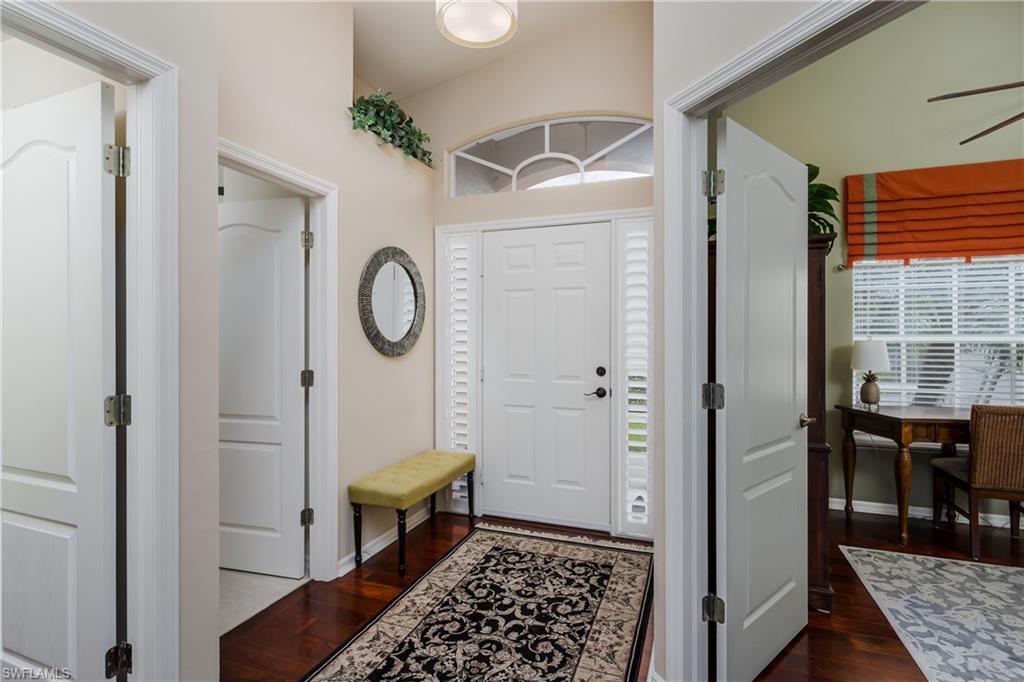 6658 Castlelawn Place, Unit 9 Naples, FL 34113 - Photo 5 of 38 Entry foyer with wood-finish flooring and a decorative area rug