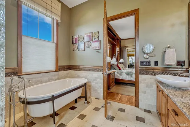 a spacious bathroom with a granite countertop sink and a mirror