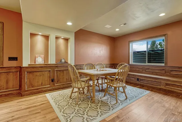 a view of a a dining room with furniture window and wooden floor