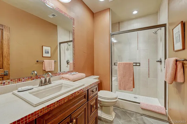 a bathroom with a sink toilet and shower