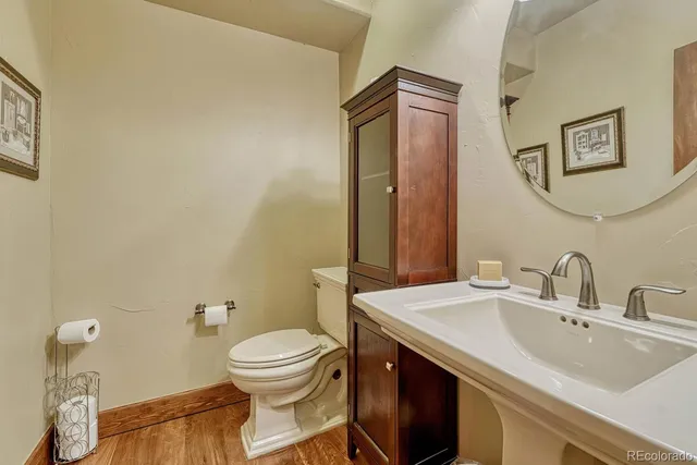 a bathroom with a toilet sink and mirror