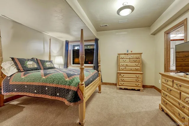 a bedroom with a bed and a dresser