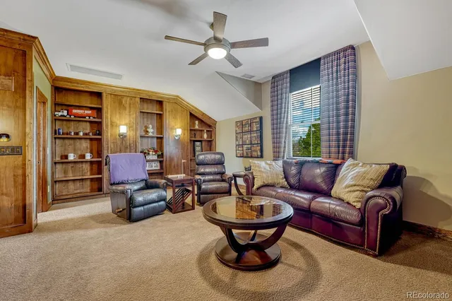 a living room with furniture a rug and a chandelier