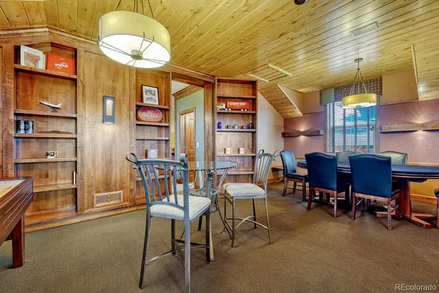 a view of a dining room with furniture and chandelier