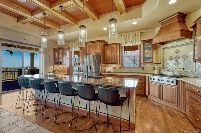 a kitchen with a sink and chairs