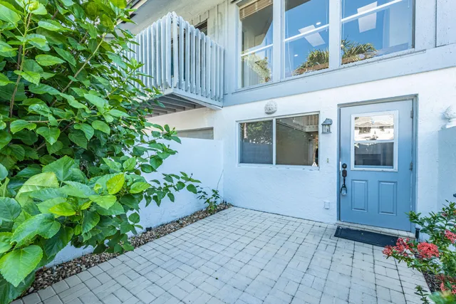 a view of a room with wooden floor and windows