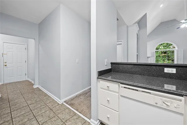 a kitchen with granite countertop a sink and a stove