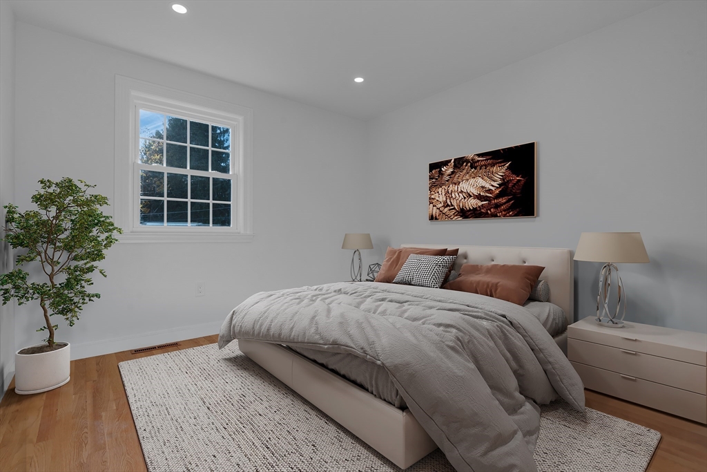 67 Cushing Road Westwood, MA 02090 - Photo 25 of 41 a bedroom with bed and a potted plant
