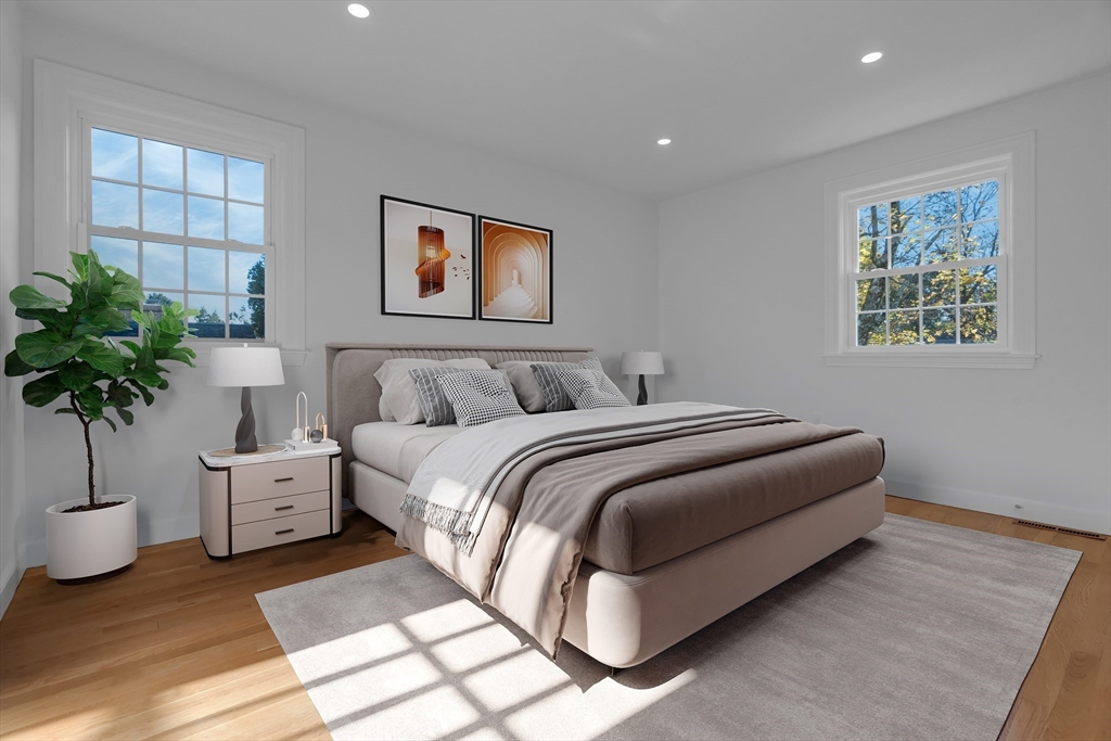 67 Cushing Road Westwood, MA 02090 - Photo 26 of 41 a bedroom with a bed and a potted plant