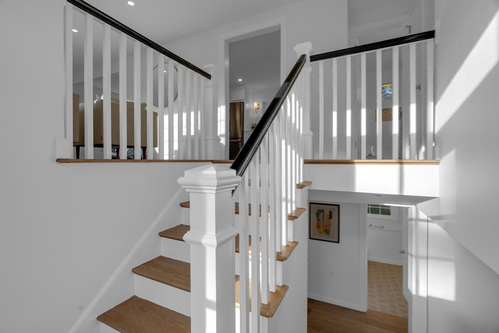 67 Cushing Road Westwood, MA 02090 - Photo 27 of 41 a view of staircase with lots of frames on wall and a window