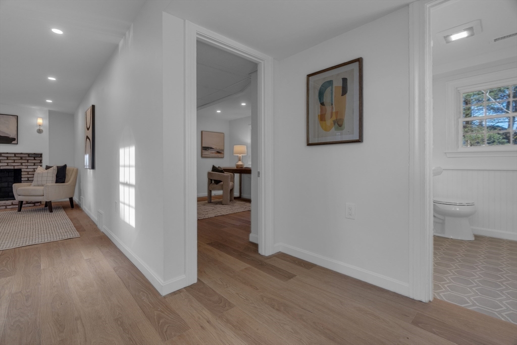 67 Cushing Road Westwood, MA 02090 - Photo 31 of 41 a view of a hallway with wooden floor and a living room