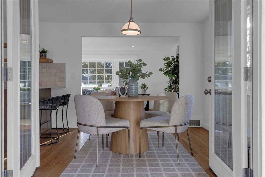 67 Cushing Road Westwood, MA 02090 - Photo 38 of 41 a dining room with furniture a chandelier and wooden floor