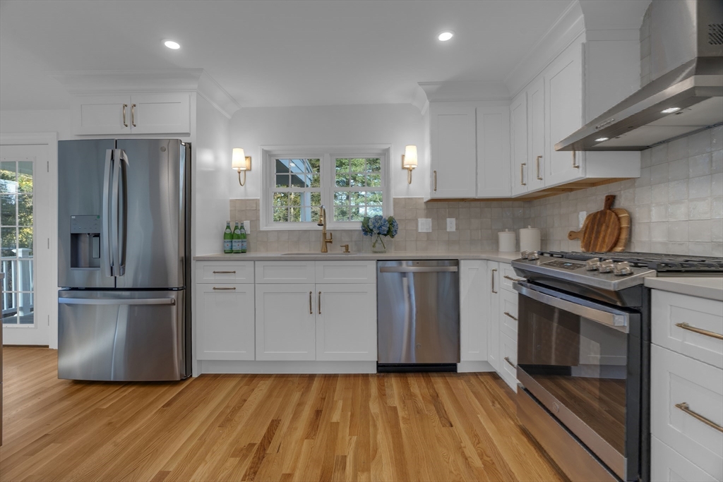 67 Cushing Road Westwood, MA 02090 - Photo 4 of 41 a kitchen with a sink wooden floor and stainless steel appliances