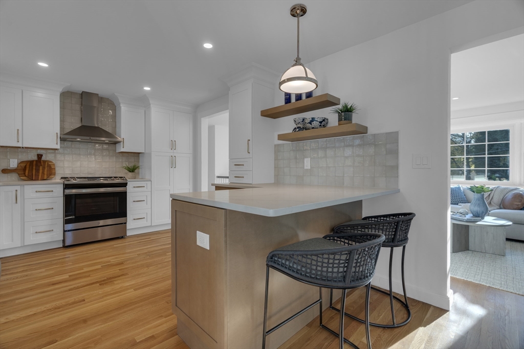 67 Cushing Road Westwood, MA 02090 - Photo 7 of 41 a kitchen with stainless steel appliances granite countertop a stove a sink a refrigerator and a wooden floors