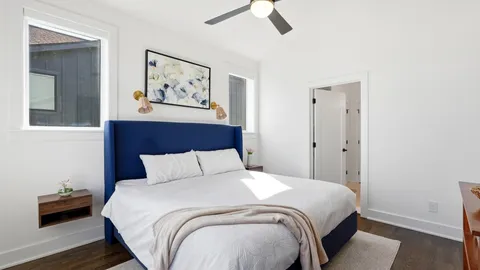 a bedroom with a bed and a painting on the wall